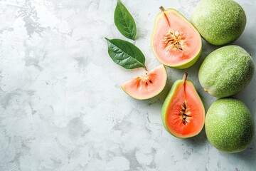 Whole Guava and Slices on a White Surface