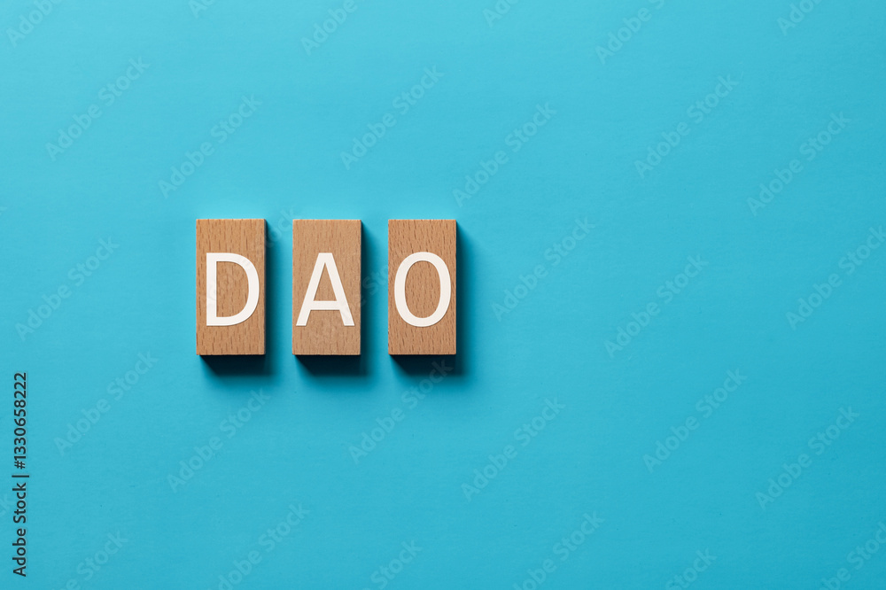 Aufkleber there is wood block with the word dao. it is an abbreviation for decentralized autonomous organizati