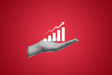 Hand holding business increases in the financial graph arrow