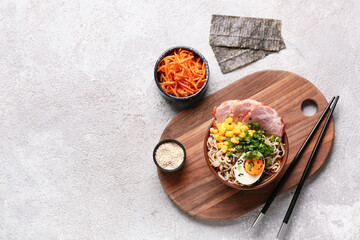 Bowl of ramen noodle soup with meat and canned corn seeds on white background