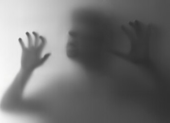Silhouette of Person Behind Frosted Glass in Mysterious Atmosphere