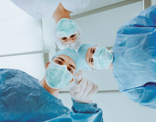 Surgeons Preparing for Operation in Hospital Operating Room Under Bright Lights
