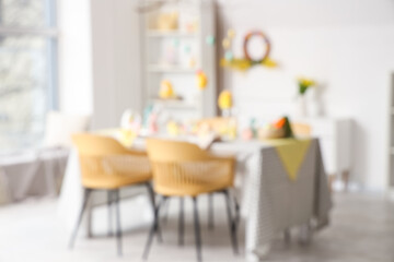 Blurred view of dining room with beautiful table setting for Easter celebration