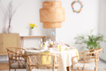Blurred view of dining room with beautiful table setting for Easter celebration