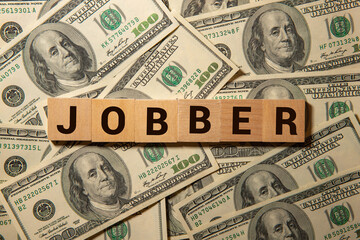 Yellow note with text WE ARE HIRING stick on wood background