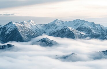 Fototapeta premium Majestic Snow-Capped Mountains Rising Above a Sea of Fog in a Beautiful Winter Landscape at Sunrise with Soft Light and Serene Atmosphere