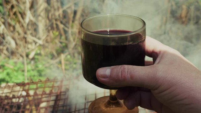 Burning Wood Fire Barbecue and a Glass of Wine
