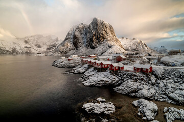 Norwegian fishing village under sunrise with rainbow at Hamnoy, Lofoten Islands