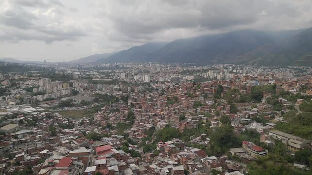 Aerial view of Caracas, the Petare neighborhood, the largest slum in Venezuela and latin america, with the Avila Mountain in the background.