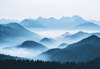 Obraz premium Serene Mountain Landscape with Misty Valleys and Blue-Hued Peaks in the Background Capturing Tranquility and Natural Beauty of the Wilderness