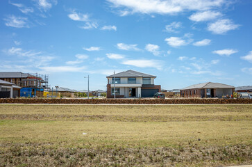 A new housing development in an outer suburb of Melbourne, Australia shows various stages of...