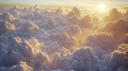 Aerial sunset view above fluffy clouds.