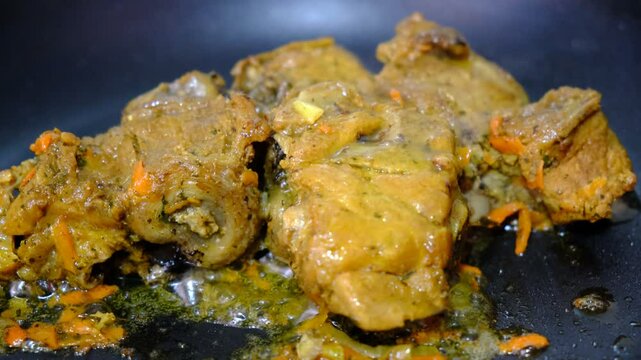 Braised ossobuco with vegetable sauce featuring carrots cooked in an iron pan.