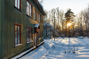 Facade of a wooden residential building against a snowy landscape