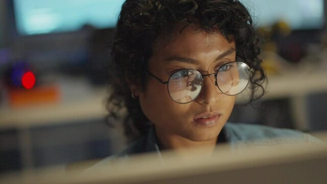 Late-night programming comes alive as an intelligent Engineer delves deep into data-driven solutions.Asian coder typing HTML in a digital workspace, engaging in research and software development.