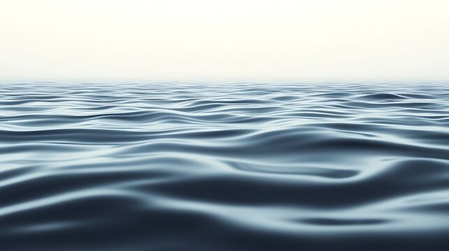 Calm water surface reflecting a soft, hazy light in a serene atmosphere.