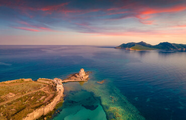 Breathtaking sunrise on Ionian sea. Incredible morning view from flying drone of old Methoni...