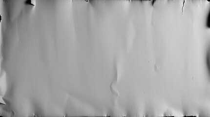 An attractive and timeless long exposure black and white shot of antique parchment paper with charred edges that captures motion or light trails