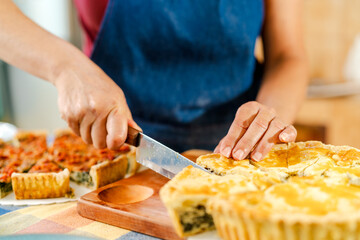Chef cutting and serving freshly baked chard pie