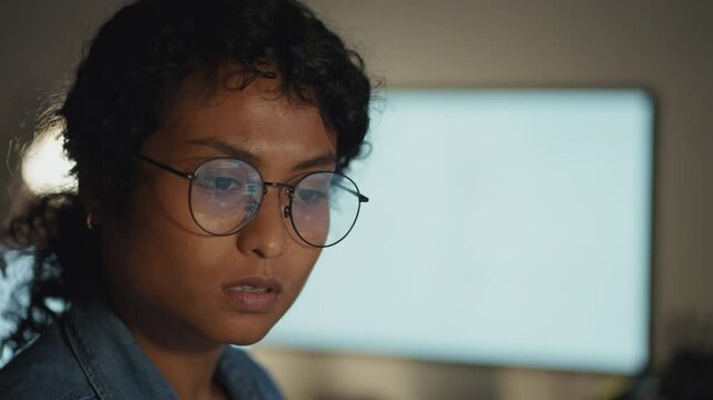 An inspiring close-up of a woman coding late at night, revealing the blend of creativity and technology in her craft.