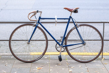 Vintage seventies racing bicycle. Navy blue colors with the classic leather brown saddle. Park...