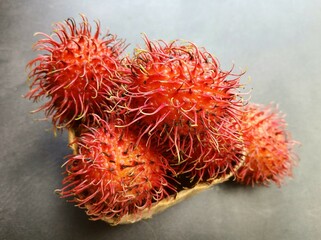 Fresh rambutans on dark background