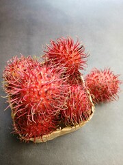 Fresh rambutans on dark background