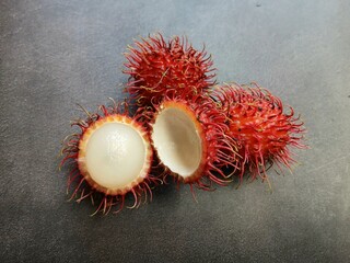 Fresh rambutans on dark background