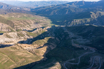 Fototapeta premium Aerial drone photo of mountain and valley landscapes from Vardenyats (Selim) Pass, connecting Sevan to Vayots Dzor in Armenia. A historic silk road travel route with scenic highland views