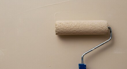 Obraz premium Paint Roller on Beige Wall: Home Improvement and DIY Project