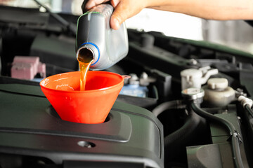 Refueling and pouring oil quality into the engine motor car Transmission and Maintenance Gear...