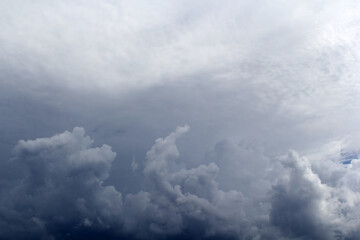 Grey gray storm clouds in an overcast sky textured background