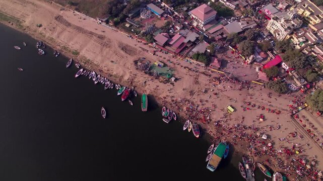 assi ghat with ganga river and boats at kashi, varanasi, uttar pradesh, india. day time, top down, drone shot, 4k.