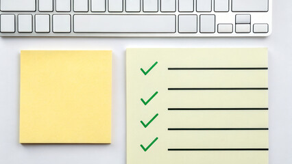 Productivity hacks concept. A keyboard with sticky notes featuring a checklist and a blank note for reminders.