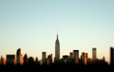 Fototapeta premium Blurred Cityscape At Sunset With Prominent Skyscraper
