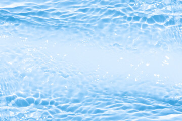Blue water with ripples on the surface. Defocus blurred transparent blue colored clear calm water surface texture with splashes and bubbles. Water waves with shining pattern texture background.