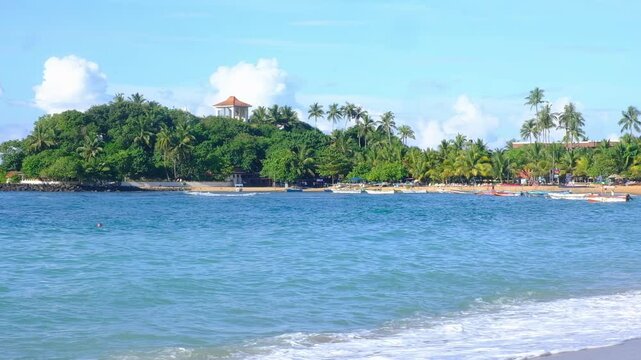 Unawatuna is a beach with a sandy coastline of about one km in Sri Lanka. The sand here is soft and golden, the water is crystal clear, with a turquoise hue. The beach is surrounded by tropical vegeta