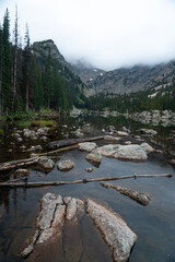 Misty morning view of lake and mountains in Rocky Mountain National Park