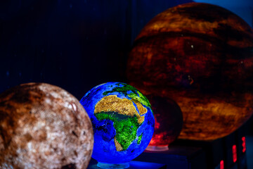 The illuminated globe and other planets provide a stunning glimpse into the beauty and complexity of the solar system.
