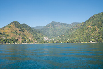 Fototapeta premium Mountains surrounding Lake Atitlan on a sunny day, Guatemala