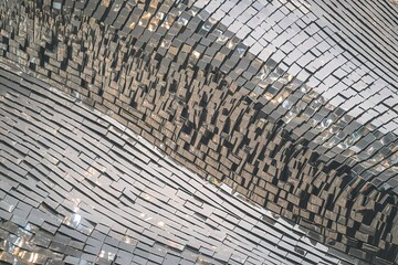 a shimmering, textured surface that resembles a mosaic of small, reflective, and irregularly shaped objects