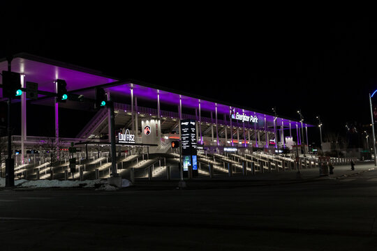 St. Louis, Missouri, USA - February 21, 2025: The Energizer Park sports arena, home to the MLS soccer team St. Louis City SC, at night lit up with purple lights .