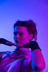 A futuristic portrait bathed in neon blue and pink light, highlighting a dramatic expression, avant-garde fashion, and an intense, dreamlike mood filled with depth and emotion