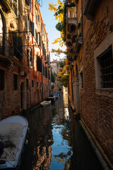 Sunlit Canal with Historic Buildings in Venice, Italy
