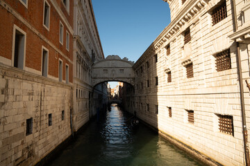 Sunlit Canal with Historic Buildings in Venice, Italy
