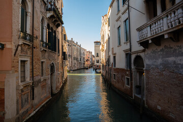 Sunlit Canal with Historic Buildings in Venice, Italy
