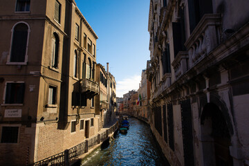 Sunlit Canal with Historic Buildings in Venice, Italy
