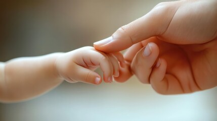 A tender moment showing a baby hand grasping an adult's finger, symbolizing love and connection between generations.