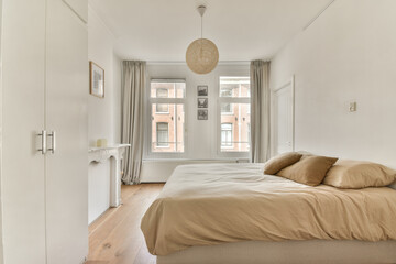 A chic and serene modern bedroom featuring a neutral color palette, soft bedding, natural light, and minimalist decor elements that create a calming atmosphere.
