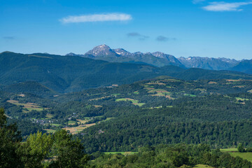 Naklejka premium Pic de l'aiguille du midi in the Pyrenees in the distance, with the countryside in the foreground,